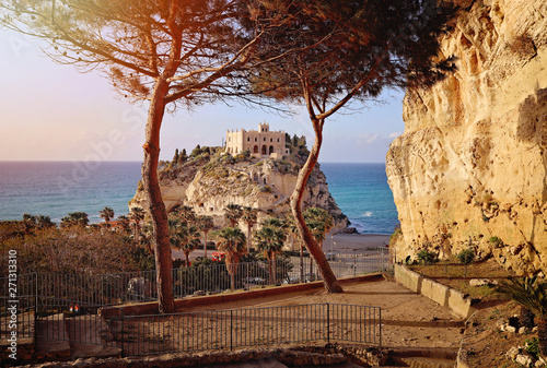 beautiful italian town Tropea, in south of Italy with the iconic beach, old town and church at the cliff. Sunset