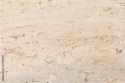 Closeup of beige porous stone textured wall. Neutral beige nature background for design and skins.