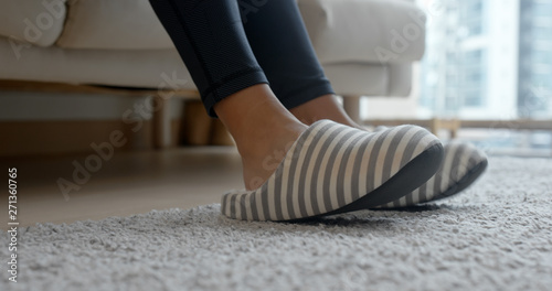 Woman wearing slipper at home