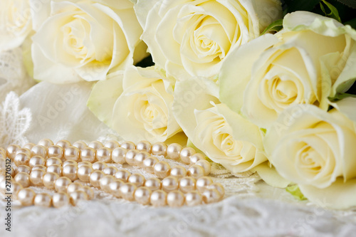 Romantic concept with roses bouquet and pearl necklace