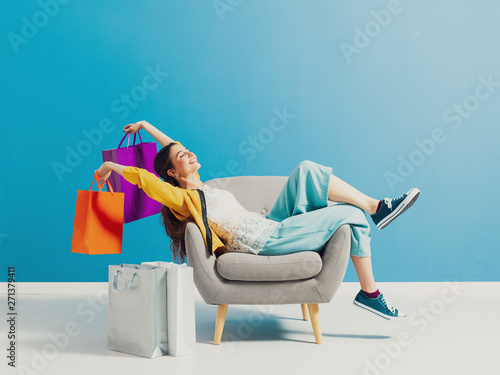 Cheerful shopaholic woman with shopping bags