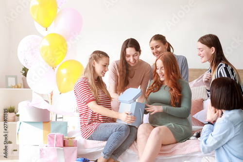 Beautiful pregnant woman and her friends at baby shower party