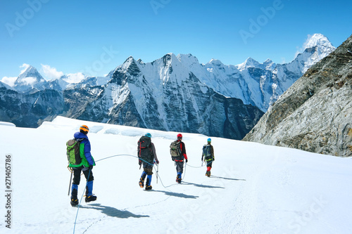 Climbers reaches the summit of mountain peak. Success, freedom and happiness, achievement in mountains. Climbing sport concept.