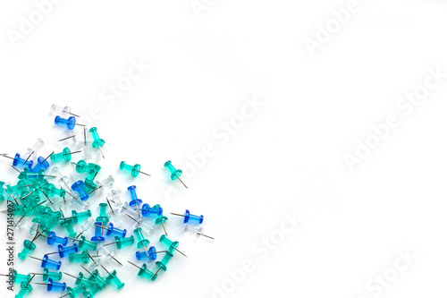 Blue, turquoise and transparent buttons laid out on the side on an isolated white background, with space for text, top view