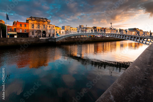 Ha'penny Bridge is over river Liffey in sunset, Dublin, Ireland