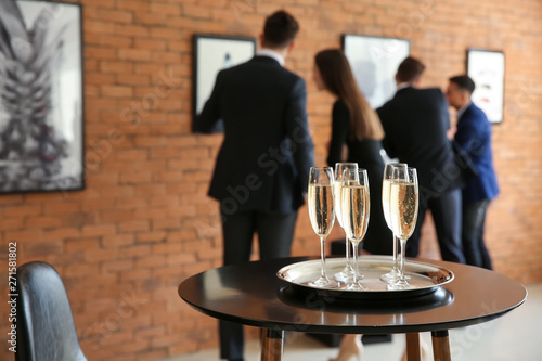 Glasses of champagne on table in art gallery