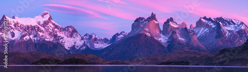 Torres del Paine National Park with snow capped mountains (Cordillera Paine) and calm lake of Pehoe at the sunrise Chile