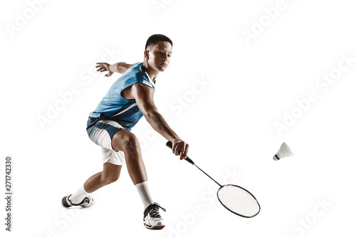 Little boy playing badminton isolated on white studio background. Young male model in sportwear and sneakers with the racket in action, motion in game. Concept of sport, movement, healthy lifestyle.