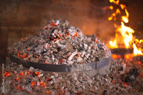 Traditional croatian dish peka in iron bell under glow