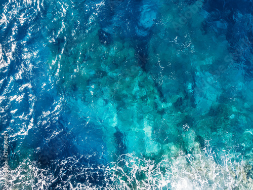 Raging blue water of open Mediterranean Sea with turquoise bottom. top view