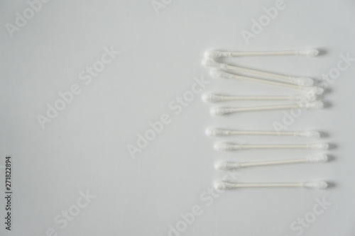 Q-tip, or cotton bud swab top view on white background with horizontal blank empty space for copy or text; Features best health care hygiene practices to clean ear.