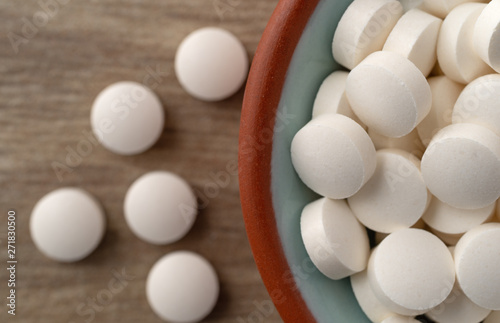 DHEA pills in a bowl on a table