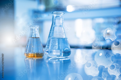 two glass flask in chemical science laboratory with molecular structure in blue background