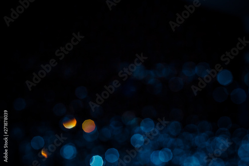 Abstract blue bokeh texture on black