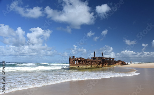 The rusty wreck of the vessel Maheno on the shores of Fraser Island (Queensland, Australia). The antique rusty and damaged boat and corrosion in the ocean sea.