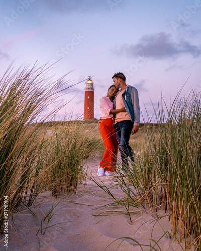 couple lighthouse Texel Netherlands, men and woman on vacation Dutch Island texel
