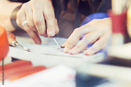 Engraver. Detail of hands of young craftman