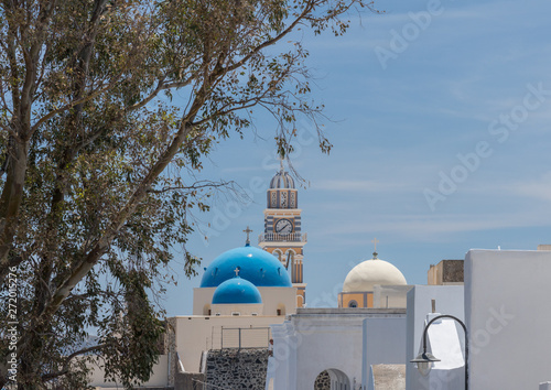 Skyline with clock tower and domes in village of Fira on Santorini