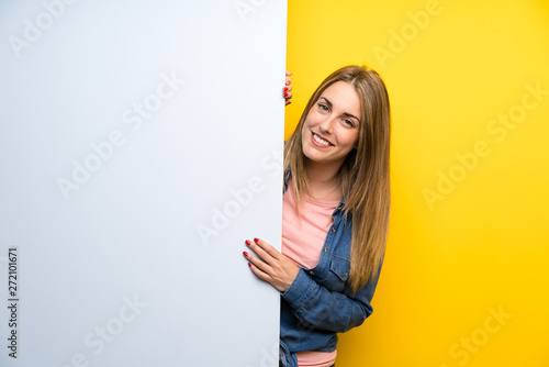 Happy Young woman holding an empty placard