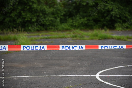 The symbol of the Polish Police on the tape separating the crime scene