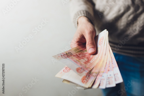 Russian rubles banknotes in a man's hand.