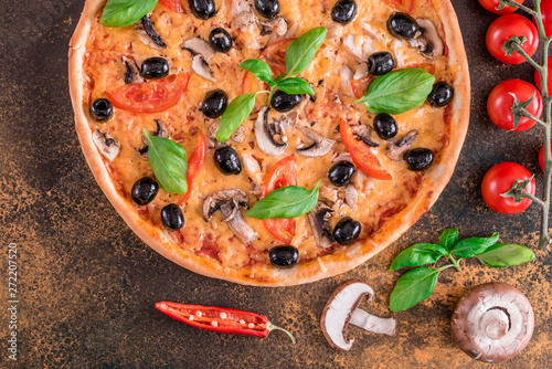 Tasty fresh hot pizza against a dark background. Pizza, food, vegetable, mushrooms. It can be used as a background