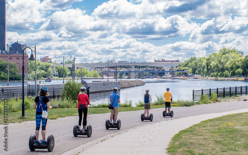 People are riding Segway along Mississippi River