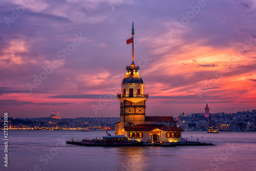 Fiery sunset over Bosphorus with famous Maiden's Tower (Kiz Kulesi) also known as Leander's Tower, symbol of Istanbul, Turkey. Scenic travel background for wallpaper or guide book