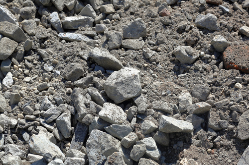 Gray textured surface of a heap of construction pebbles and gravel