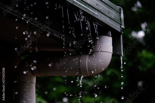 Overflowing Gutter During a Summer Rainshower