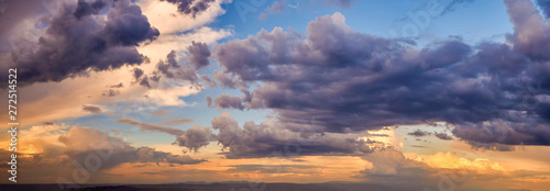 Dramatic light through the clouds against the backdrop of an exciting, bright stormy sky at sunset. panorama, natural composition