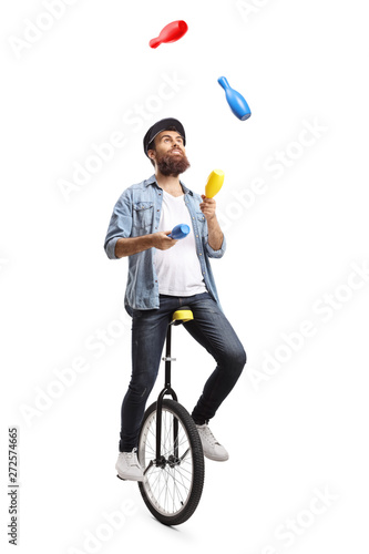 Bearded man on a unicycle juggling with clubs