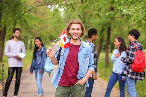 Young student with Canadian flag outdoors