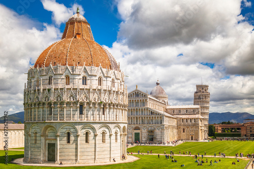 The Pisa Baptistery of St. John, The Cathedral and The Leaning Tower of Pisa in Square of Miracles at sunny day, Tuscany region, Italy.
