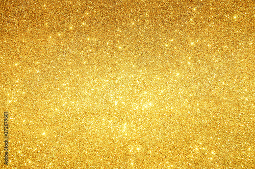 gold Sparkling Lights Festive background with texture. Abstract Christmas twinkled bright bokeh defocused and Falling stars. Winter Card or invitation