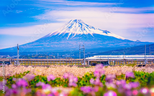 Shinkansen bullet train passing by Mount Fuji, Yoshiwara, Shizuoka prefecture, Japan.