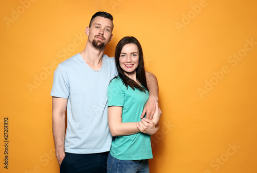 Happy young couple on color background