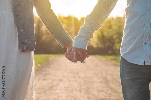 A young couple spends time together outdoors. Couple having fun summer time