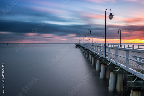 Wooden pier in Gdynia Orlowo in the morning with colors of sunrise. Poland. Europe.