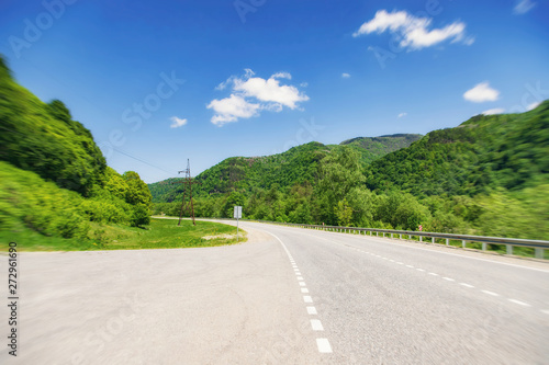 asphalt road passes through a mountain gorge