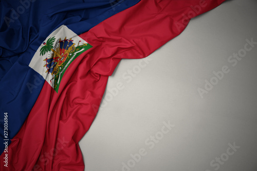waving national flag of haiti on a gray background.