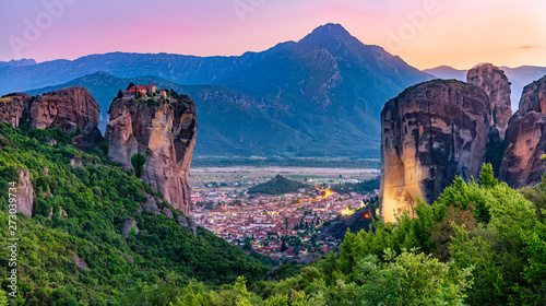 Tourist attraction to beautiful place of Meteora, monasteries on the cliffs in sunset light in Greece