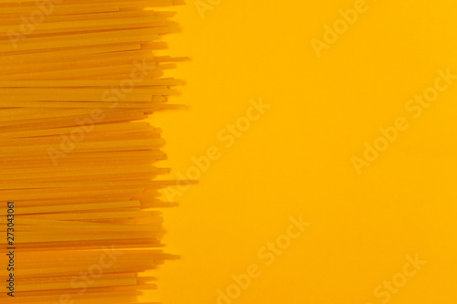 Spaghetti pasta on a yellow background