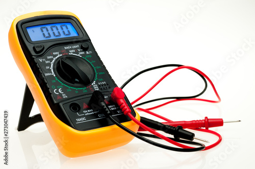 Digital multimeter with probes and blue backlit display on a white background