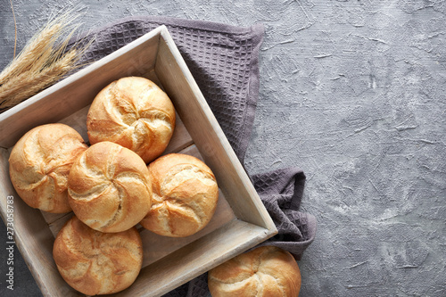 Crusty round bread rolls, known as Kaiser or Vienna rolls on linen towel