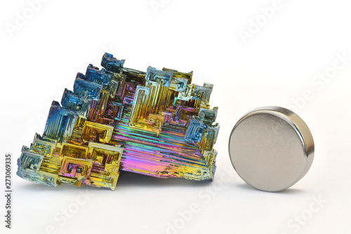 Bismuth crystals and a neodymium magnet isolated on white. This is the most strongly diamagnetic element and also the heaviest that is not radioactive.