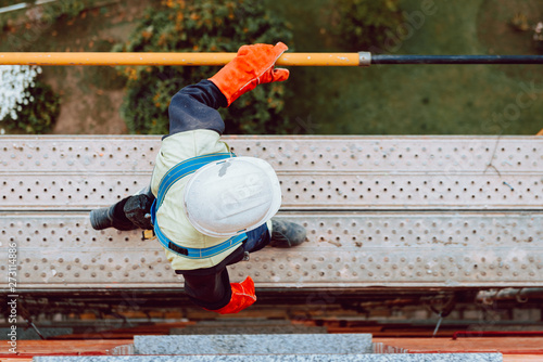 workers work removing a scaffolding at high altitude in Oviedo, Asturias, Spain.