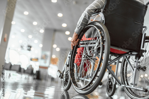 Elderly lady is using a wheelchair in airport