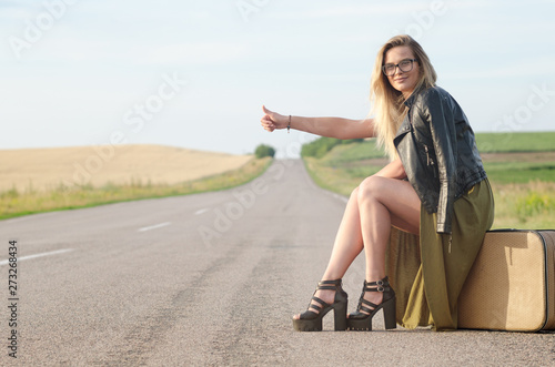 Portrait of a lady standing by the road.