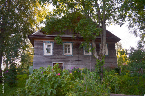 Wooden house with carved windows in Vologda Russia . Russian style in architecture. Rustic russian house with garden